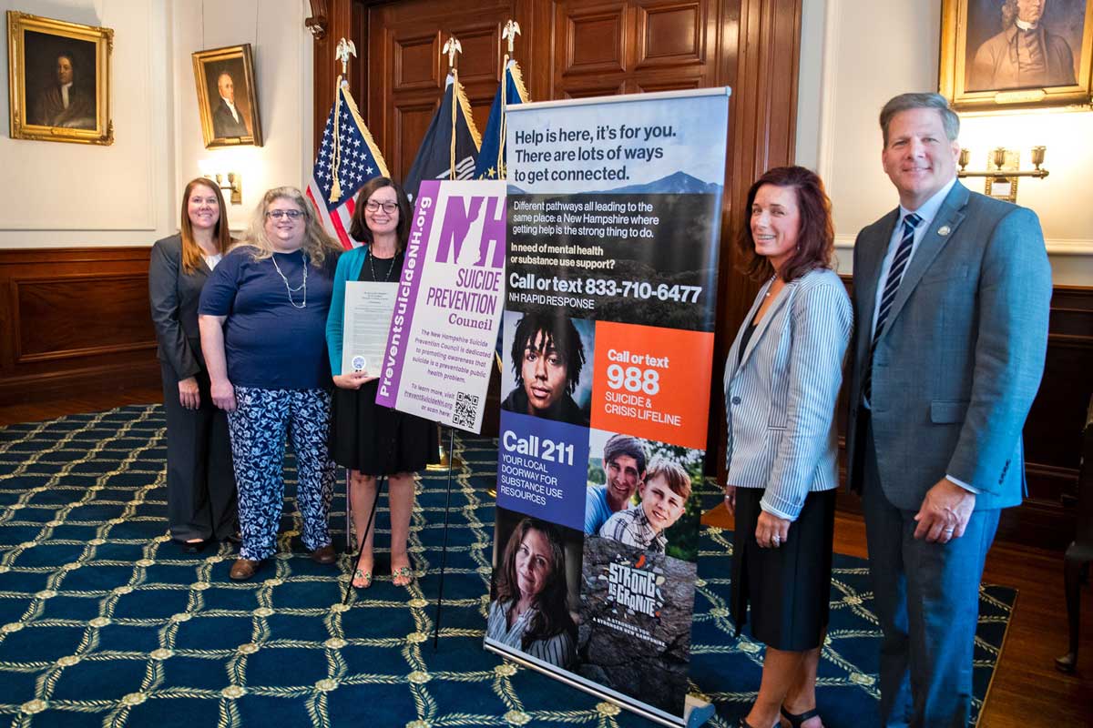 Group of people (Left-to-right) Shamera Simpson, American Foundation for Suicide Prevention and New Hampshire Suicide Prevention Council Vice Chair; Karen Privé, an individual with lived experience; Susan Stearns, NAMI New Hampshire Executive Director; Commissioner Lori Weaver, NH Department of Health and Human Services; and New Hampshire Governor Chris Sununu.